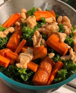 Holiday Kale Salad with Roasted Carrots and Spiced Tahini Sauce